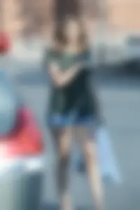 Cutie walking in the parking lot in jean shorts