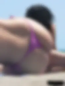 Purple thong topless lady on the beach gets oiled up by her husband