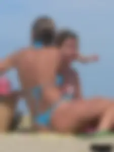 Sexy lady on the beach in a blue thong bikini