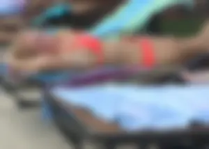 Sexy blonde lady in a bikini with a great body laying by the pool