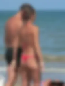 A bunch of hot babes on the beach in thong bikinis