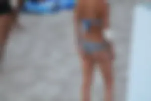 Sexy girl playing beach volleyball in a bikini