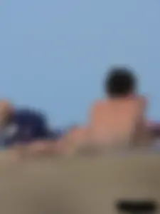 Sexy babe with a nice body topless and in a thong on the beach
