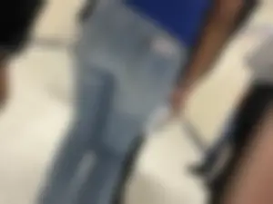Hot college booty closeup in tight blue jeans with a phone in back pocket