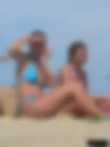 Sexy lady on the beach in a blue thong bikini