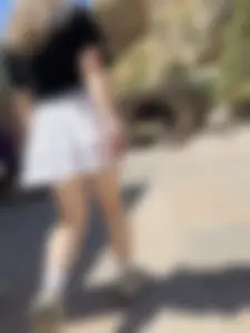 Closeups of a hot girl’s pale legs, she’s wearing a skirt