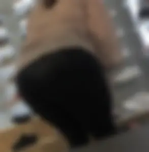 Latina milf in see leather see thru leggings sitting down.