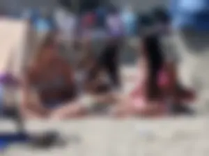 Sexy brunette on the beach in a bikini with great tits
