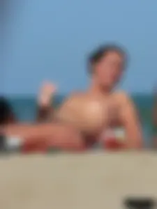 Bunch of sexy babes on the beach topless and in thong bikinis