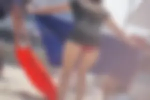A group of teens in bikinis on the beach