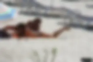 Topless milf and her topless daughter on the beach