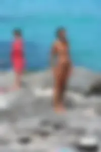 Older lady on a nude beach showing her body