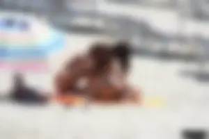 Topless milf and her topless daughter on the beach