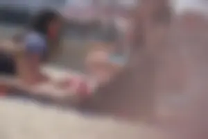 A group of teens in bikinis on the beach