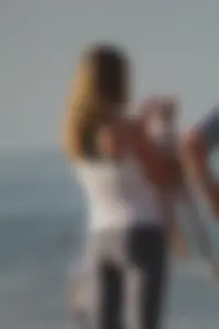 Skinny blonde on the beach in tight grey leggings