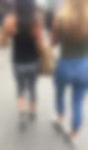 Sexy girl walking in grey patterned leggings with friend in tight jeans
