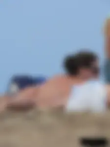 Sexy babe with a nice body topless and in a thong on the beach