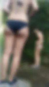 Sexy girl with glasses in a black bikini up close