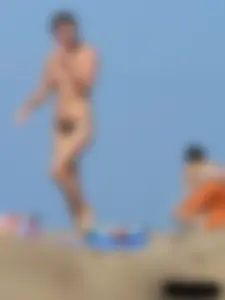 Sexy babe with a nice body topless and in a thong on the beach