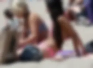 Sexy brunette on the beach in a bikini with great tits
