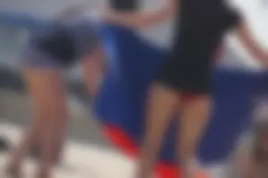 A group of teens in bikinis on the beach