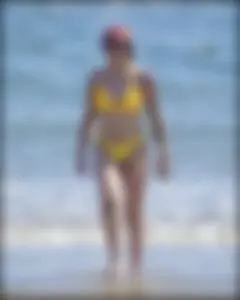 Sexy tattooed beach brunette with a great ass in yellow thong bikini