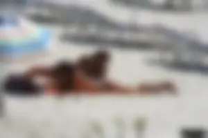 Topless milf and her topless daughter on the beach