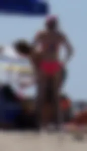 Sexy and skinny girl on the beach in pink bikini