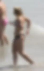 Big boobed thick blonde on the beach in a bikini