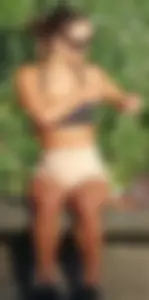 Tanned fitness woman showing off her toned physique & amazing butt