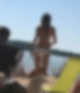 Swedish beach blonde girl in white and green bikini