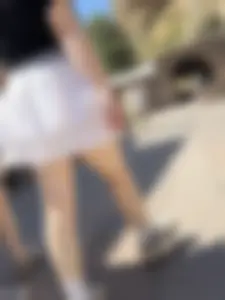 Closeups of a hot girl’s pale legs, she’s wearing a skirt