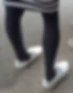 Slim legs in black pantyhose street closeups