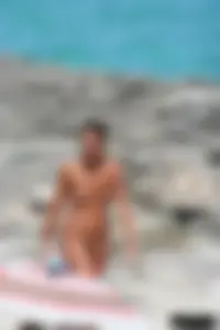 Older lady on a nude beach showing her body