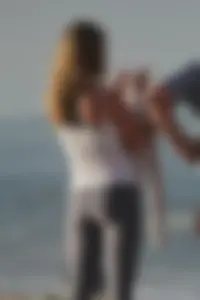 Skinny blonde on the beach in tight grey leggings