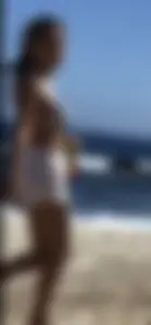 Beautiful brunette teen babe on the beach with a perfect body