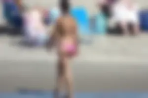 Brunette on the beach in a bikini with nice ass and small boobs