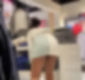 Sexy ass candid braless ebony employee in a tiny skirt showing her ass cheeks, thong line and pokies
