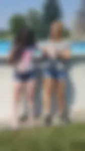 Couple of Young Girls in Jean Mini Shorts on the Backyard Pool