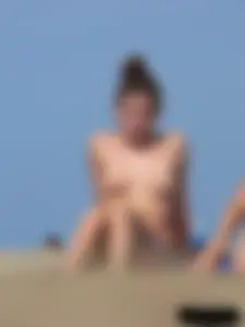 Sexy babe with a nice body topless and in a thong on the beach