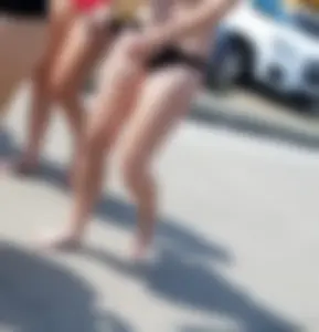 Cute brunette looking sexy in black bikini with friends