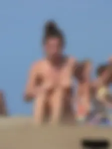 Sexy babe with a nice body topless and in a thong on the beach