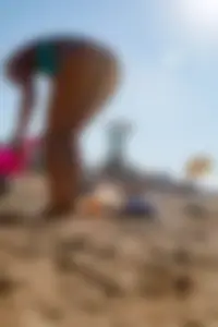 Sexy blonde milf on the beach in blue thong bikini and showing nice camel toe