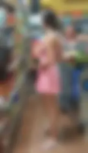Teen in awesome legs wearing a short dress and slippers at the supermarket