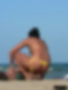 Bunch of sexy babes on the beach topless and in thong bikinis