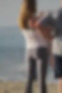 Skinny blonde on the beach in tight grey leggings