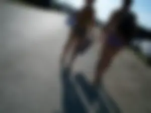 Girls in Sandals and Swimsuits Walking on Asphalt Beach Creepshot