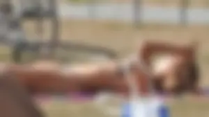 Lady at the park stripping down to her bikini to lay out