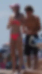 Sexy and skinny girl on the beach in pink bikini