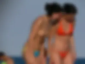 Topless beach babe with nice tits and ass in blue thong bikini